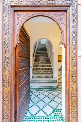 an entrance to a staircase with a door and a tile floor at Riad Mimouna - Rooftop view & Breakfast included - 4 Rooms - Fully private in Marrakech