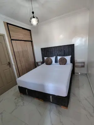 a bedroom with a large white bed with two pillows at Marrakech MAROCCO in Marrakech