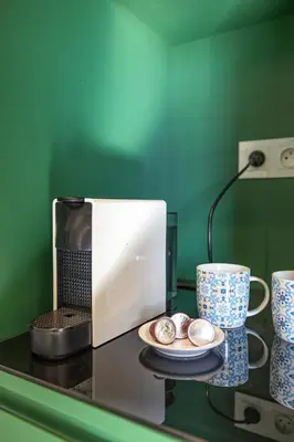 a counter with a plate and two cups and a microwave at Charming 1-BR with Terrace, AC, Parking-City Center in Marrakech