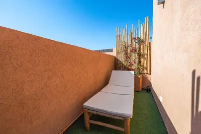 a bench sitting on the side of a building at Charming 1-BR with Terrace, AC, Parking-City Center in Marrakech