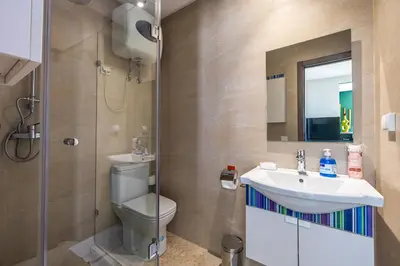 a bathroom with a toilet and a sink and a shower at Charming 1-BR with Terrace, AC, Parking-City Center in Marrakech