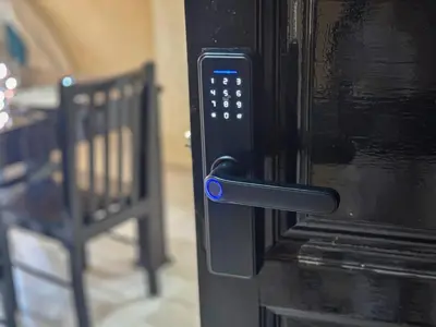 a black microwave oven with a blue button on it at Le Cosy Urbain - Proche centre, Parking & Balcon in Marrakech