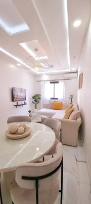 a white living room with two couches and a couch at Moderne appart NEUF Proche Aéroport et Gueliz in Marrakech