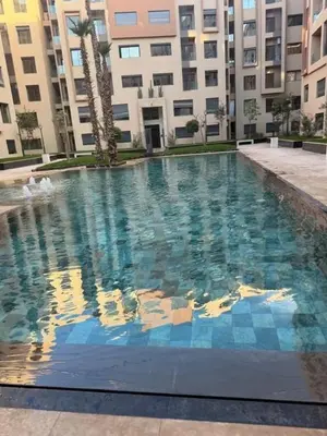 a large swimming pool in front of a building at Beautiful Apartment in Guéliz Pools & Jacuzzi in Marrakech