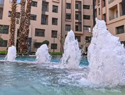 a water fountain in front of a building at Beautiful Apartment in Guéliz Pools & Jacuzzi in Marrakech