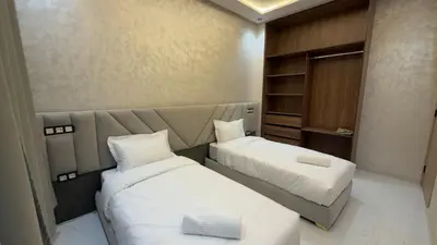 a hotel room with two beds and a couch at NEW 2 Bedrooms Apartment 15 min from City Center Marrakech in Marrakech