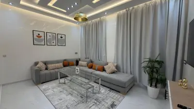 a living room with a couch and a table at NEW 2 Bedrooms Apartment 15 min from City Center Marrakech in Marrakech
