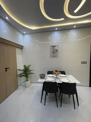 a dining room with a table and two chairs at NEW 2 Bedrooms Apartment 15 min from City Center Marrakech in Marrakech