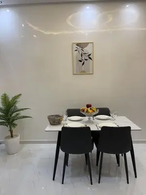 a white table with chairs and a bowl of fruit on it at NEW 2 Bedrooms Apartment 15 min from City Center Marrakech in Marrakech