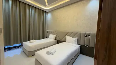a hotel room with two beds with towels on them at NEW 2 Bedrooms Apartment 15 min from City Center Marrakech in Marrakech