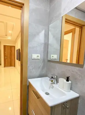 a bathroom with a sink and a mirror at Appartement coup de coeur in Marrakech