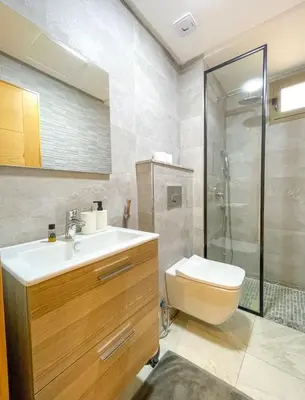 a bathroom with a toilet and a sink and a shower at Appartement coup de coeur in Marrakech