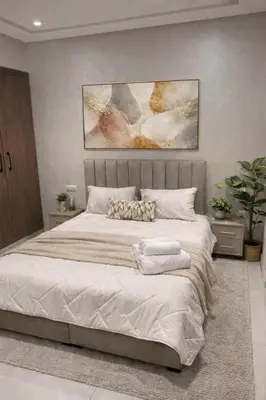 a bedroom with a large bed with white sheets at Appartement coup de coeur in Marrakech