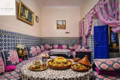 a living room with a couch and a table at Riad Le Sultana in Marrakech