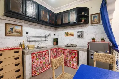 a kitchen with a sink and a stove at Riad Le Sultana in Marrakech