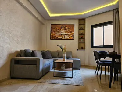 a living room with a couch and a table at Appart Cosy et confort en plein centre Marrakech in Marrakech