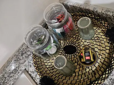 a table with glass jars on top of a sink at Appart Cosy et confort en plein centre Marrakech in Marrakech