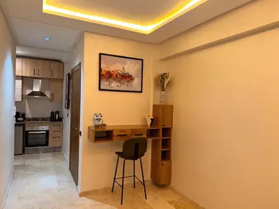 a kitchen with a desk and a chair in a room at Appart Cosy et confort en plein centre Marrakech in Marrakech