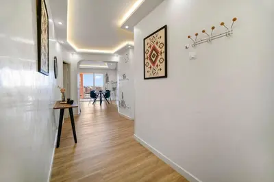 a hallway with white walls and a wooden floor at Downtown Cozy Apartment with Panoramic View in Marrakech