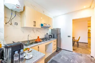 a kitchen with a sink and a refrigerator at Urban, New 2 BR Apartment in Marrakech