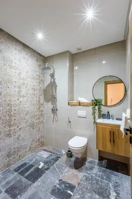 a bathroom with a toilet and a sink and a mirror at Urban, New 2 BR Apartment in Marrakech