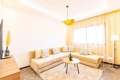 a living room with a couch and a table at Urban, New 2 BR Apartment in Marrakech