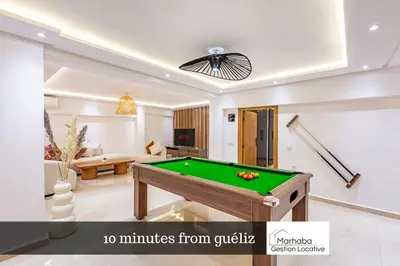 a living room with a pool table at 10 min from Stadium AFCON Green Table Loft in Marrakech