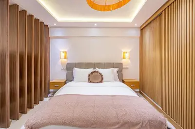 a bedroom with a large bed with two night stands at 10 min from Stadium AFCON Green Table Loft in Marrakech