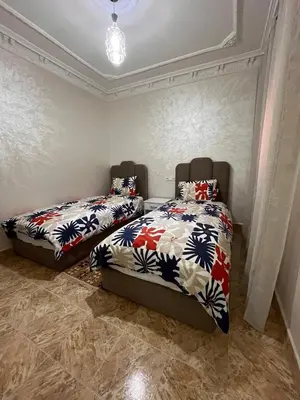 a bedroom with two beds in a room at cozy and spacious apartment in Marrakech