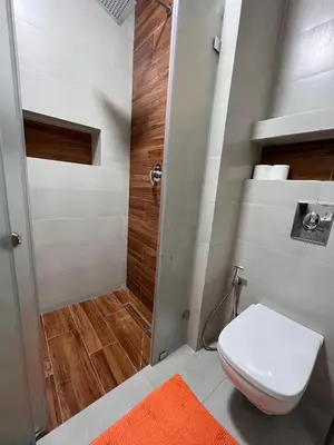 a small bathroom with a toilet and a shower at cozy and spacious apartment in Marrakech