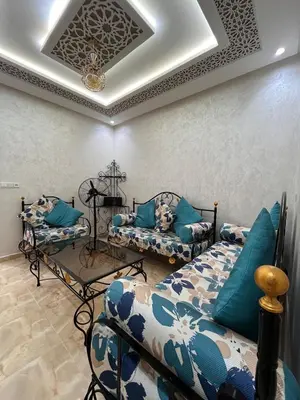 a living room with two couches and a ceiling at cozy and spacious apartment in Marrakech