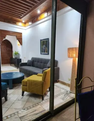 a living room with a couch and a table at Palmeraie Garden Luxury Appartement Family Only in Marrakech