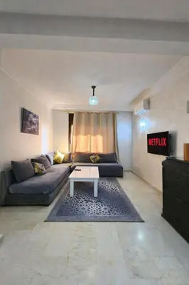 a living room with a couch and a table at Caprice Palace Residence Bella Anima in Marrakech