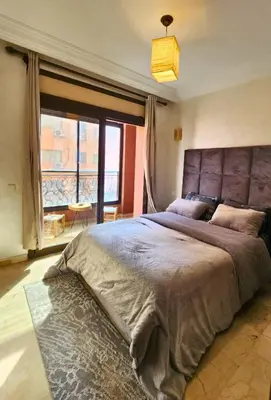 a bedroom with a large bed with a large window at Caprice Palace Residence Bella Anima in Marrakech