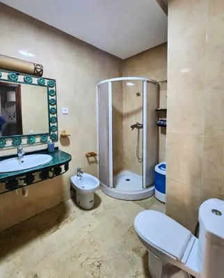 a bathroom with a shower and a toilet and a sink at Caprice Palace Residence Bella Anima in Marrakech