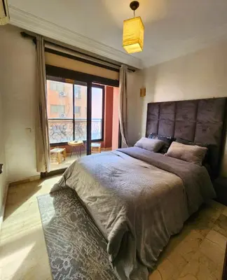 a bedroom with a large bed with a large window at Caprice Palace Residence Bella Anima in Marrakech