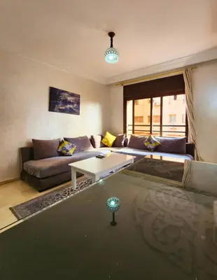 a living room with a couch and a table at Caprice Palace Residence Bella Anima in Marrakech