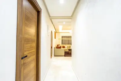 a hallway with a wooden door and a living room at Luxurious and Cozy Apartment with Parking and View in Marrakech