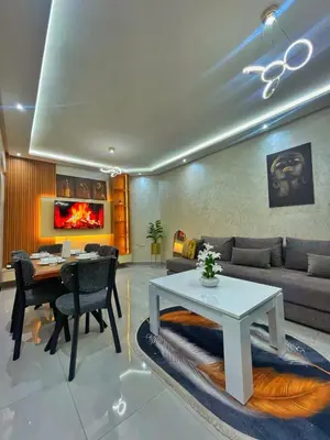 a living room with a table and a couch at apparemment 35 in Marrakech