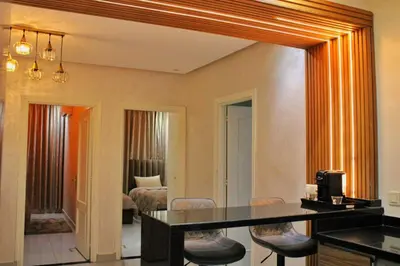 a large mirror in a living room with a table and chairs at apparemment 35 in Marrakech