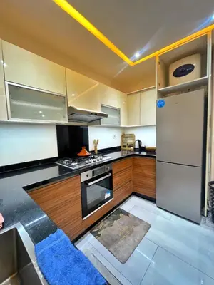 a kitchen with a stove and a refrigerator at apparemment 35 in Marrakech