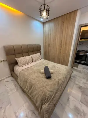 a bedroom with a bed with a hat on it at Appartement plaza in Marrakech