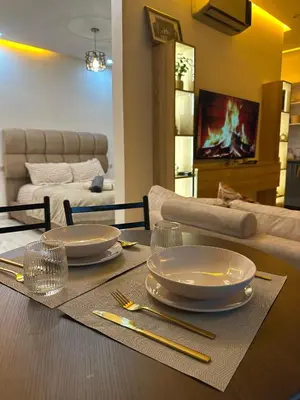 a dining room table with plates and chopsticks on it at Appartement plaza in Marrakech