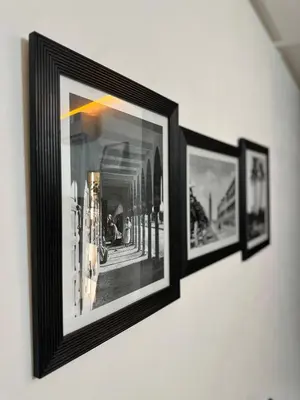 three framed pictures are hanging on a wall at Appartement plaza in Marrakech