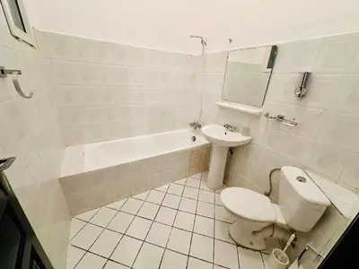 a white bathroom with a toilet and a sink at B&B Lina Stay Marrakech in Marrakech