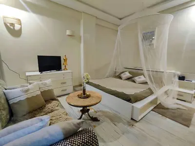 a small bedroom with a bed and a table at Nilia in Marrakech