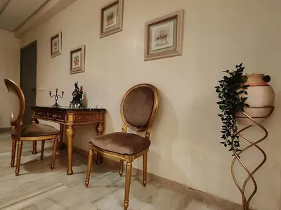 a room with two chairs and a table and a vase at Nilia in Marrakech