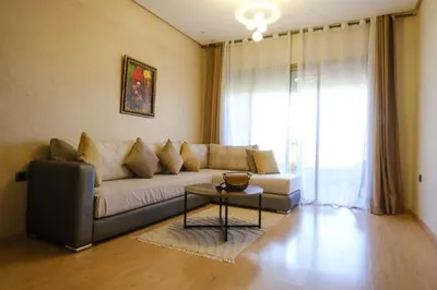 a living room with a couch and a table at Prestigia Appartment Golf & 3 Pools in Marrakech