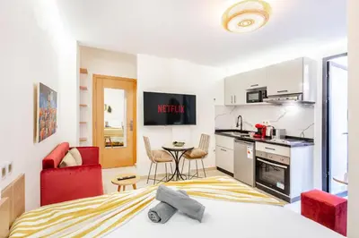 a kitchen and a living room with a bed and a table at Studio chic et cosy au cœur de Guéliz in Marrakech