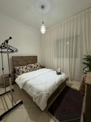 a bedroom with a large white bed and a window at Marrakech mahamid location vacances 3 chember in Marrakech